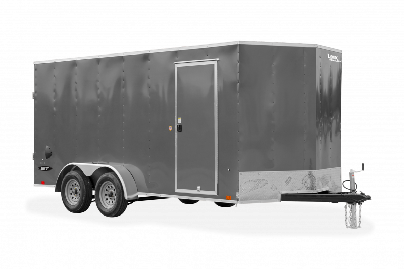 Look Trailers | Trailers | Trailer Models | ST DLX | Image of grey enclosed cargo trailer with dual axles showing the front right side of trailer with side door and a clear background | Image 3