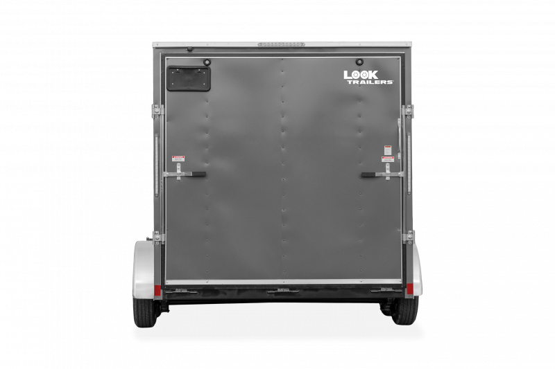 Look Trailers | Trailers | Trailer Models | ST DLX | Image of grey enclosed cargo trailer with dual axles showing the back of trailer with fold down back door clear background | Image 6